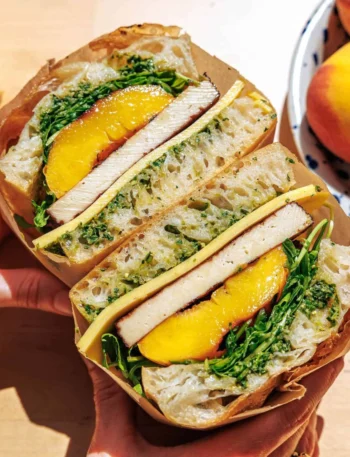 Best focaccia sandwich topped with grilled peaches and fresh ingredients