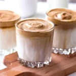 Erfrischender Eiskaffee mit Sahne und Eiswürfeln in einem Glas