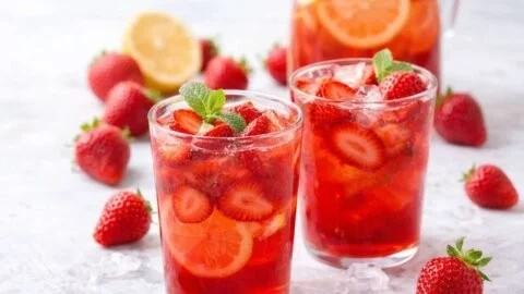 Selbstgemachte Erdbeer Limonade in einem Glas mit frischen Erdbeeren und Minze.