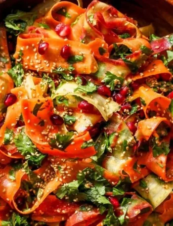 Rohkostmöhrensalat mit Zitrus-Miso-Ingwer-Dressing auf einem Teller