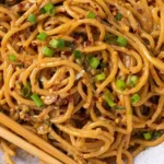Schale mit veganen Knoblauchnudeln garniert mit frischem Basilikum