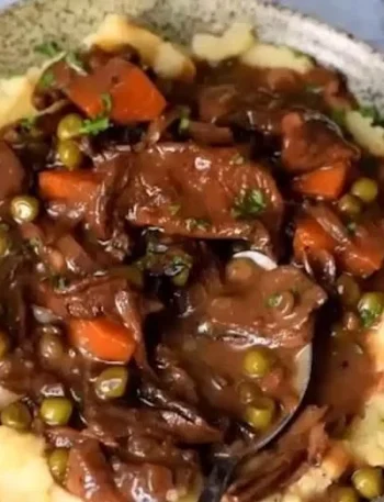Eine köstliche Schale mit veganem Mushroom Bourguignon, serviert mit frischem Brot.